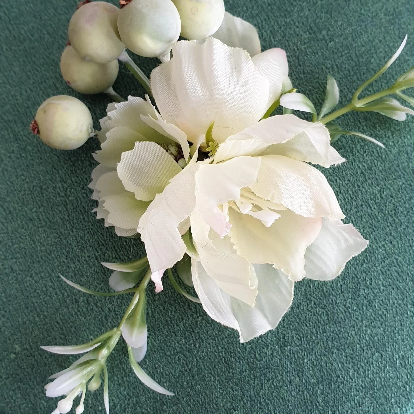 White flowers with green leaves on a textured teal background