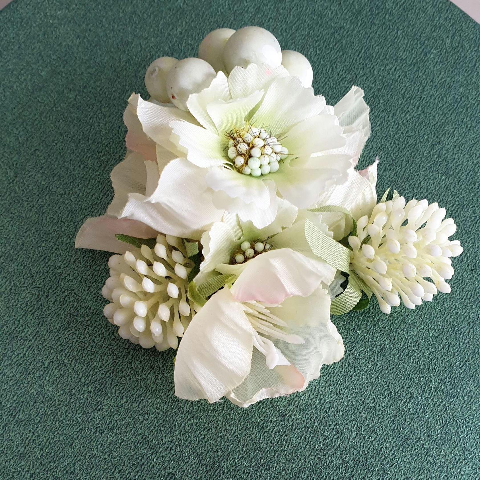 White floral arrangement on a green surface