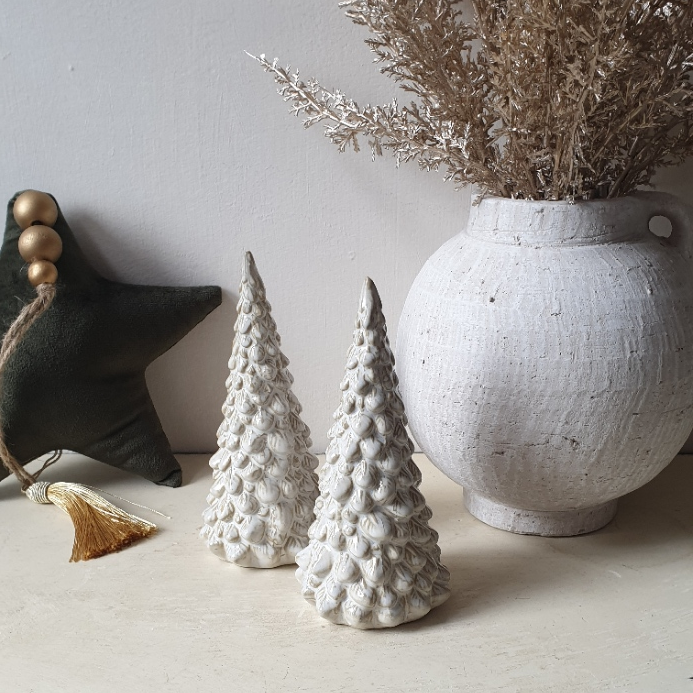 artificial wedding flowers - Two white textured Christmas trees and a vase with dried plants on a light surface.