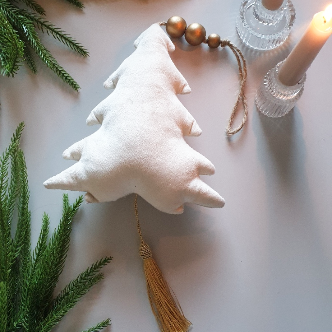 artificial wedding flowers - White fabric Christmas tree ornament with tassel on a light background