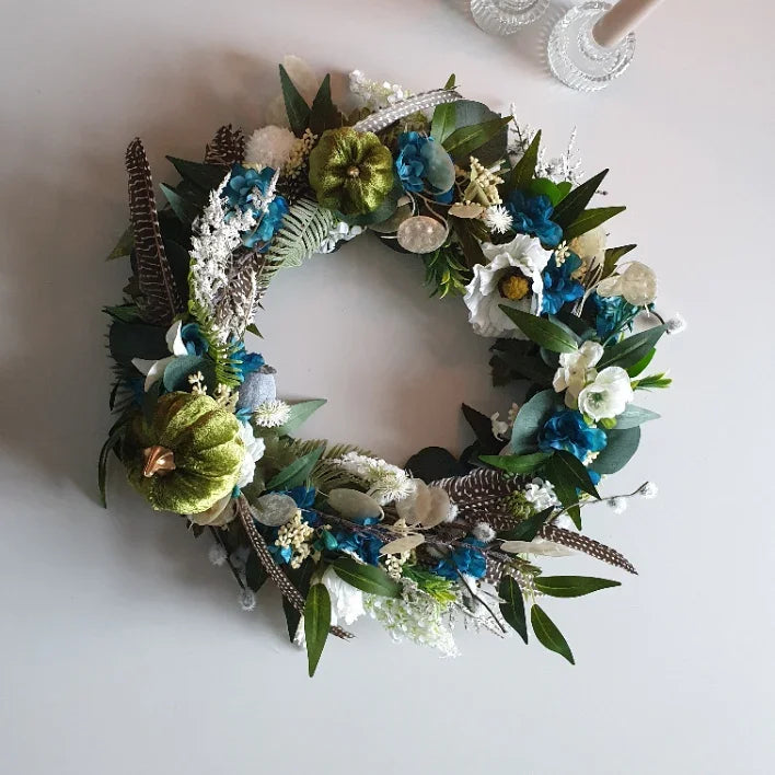 Autumn door wreath Cheshire with greenery and flowers on a white background