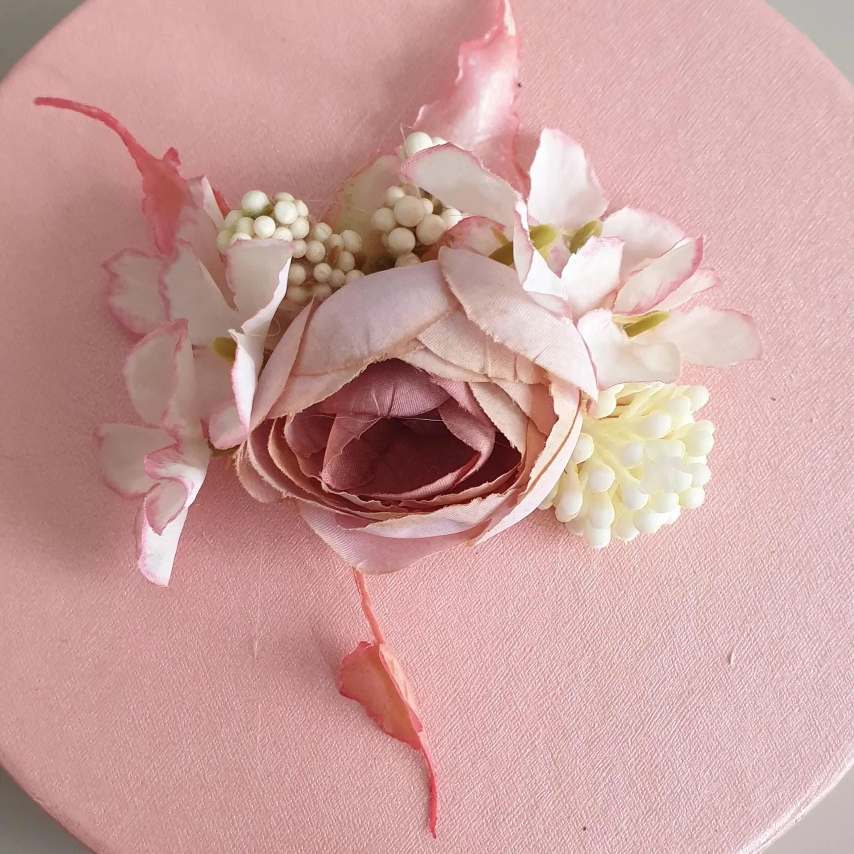 Pink flower arrangement on a pink background