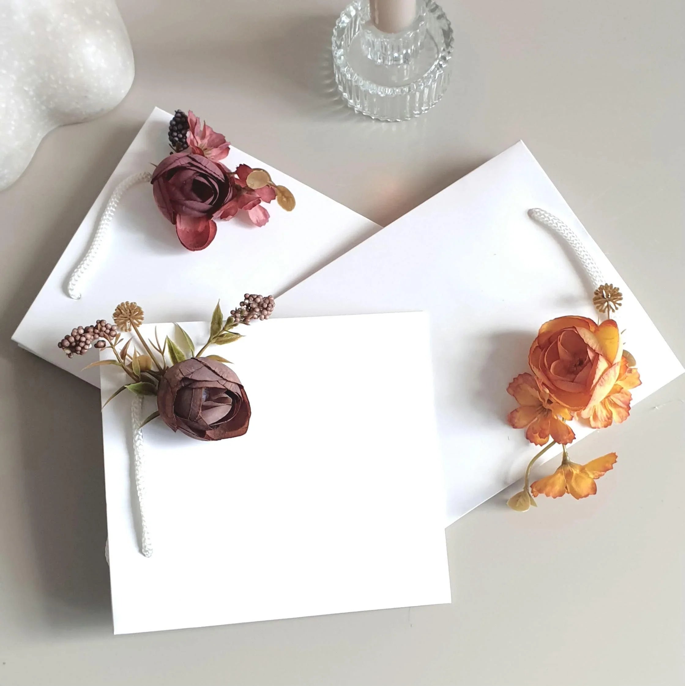 wedding flowers Cheshire - Floral decorations on white cards with a neutral background