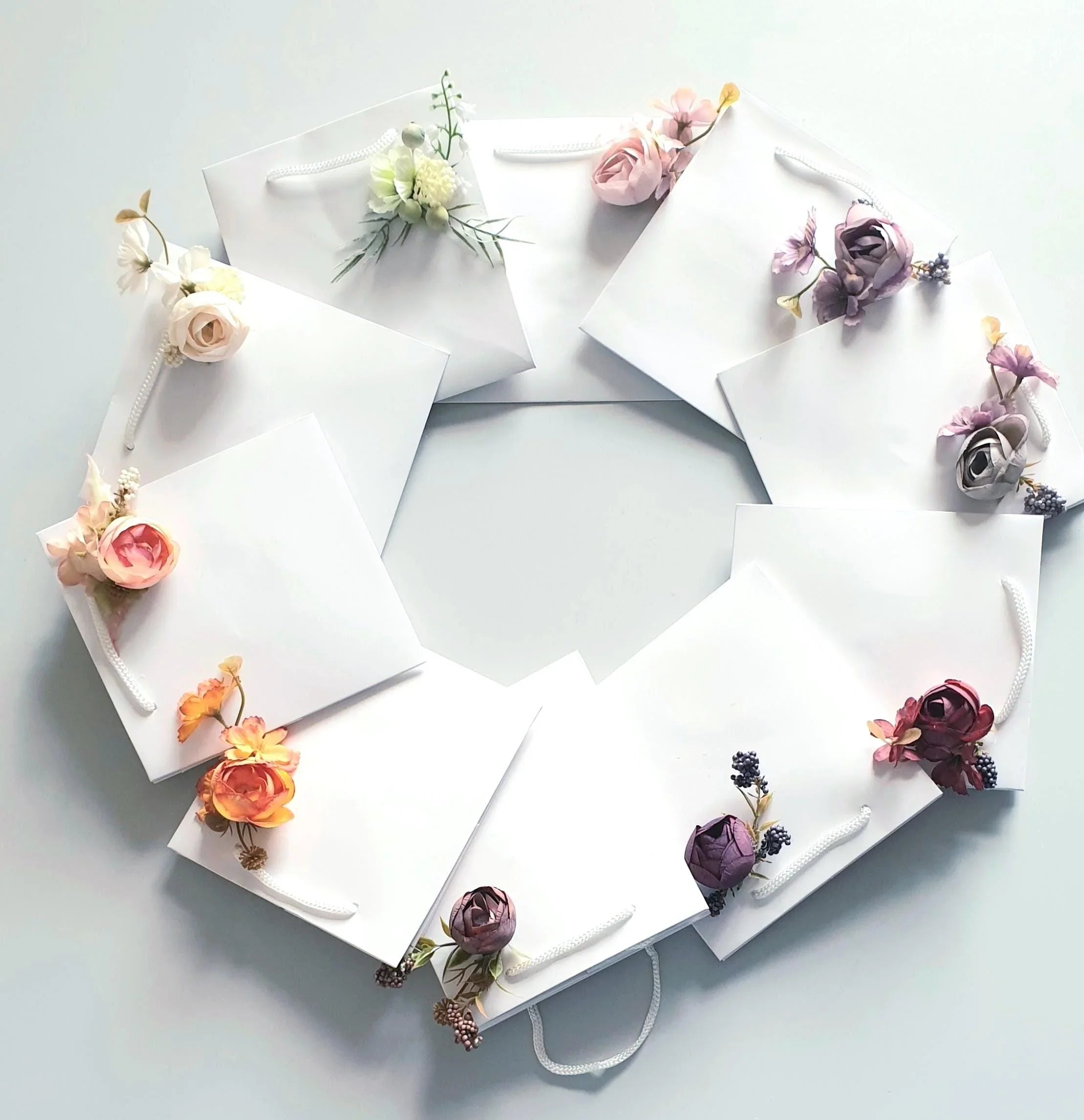 wedding flowers Cheshire - Decorative flower arrangements on white cards arranged in a circular pattern.
