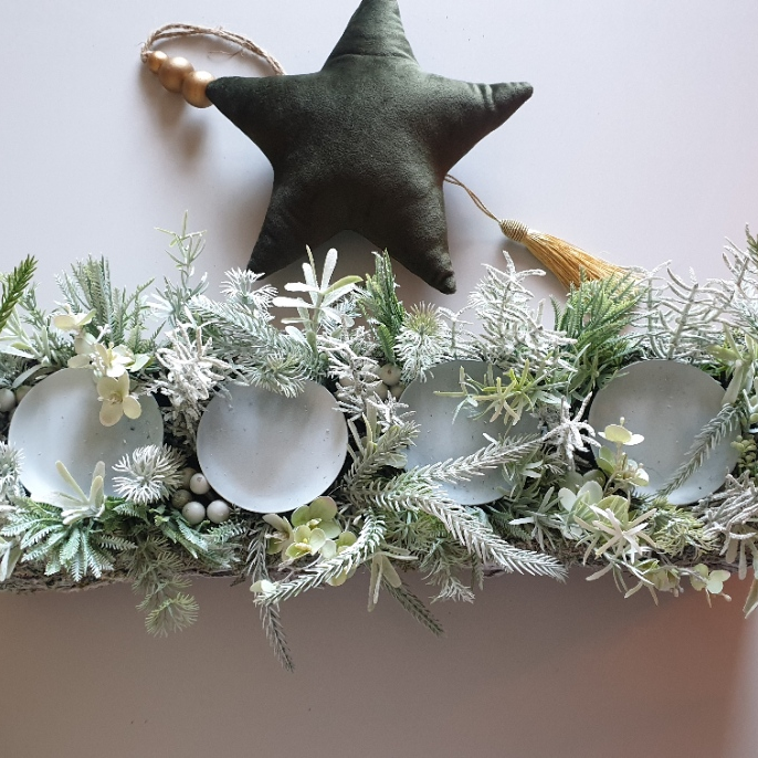 artificial wedding flowers - Decorative garland with frosted balls and a star ornament on a light background