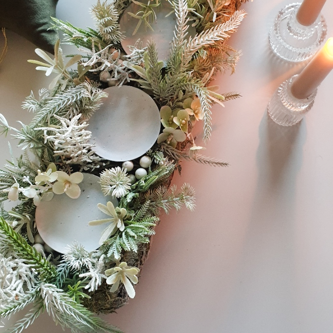 artificial wedding flowers - Decorative wreath with greenery, shells, and flowers on a white background