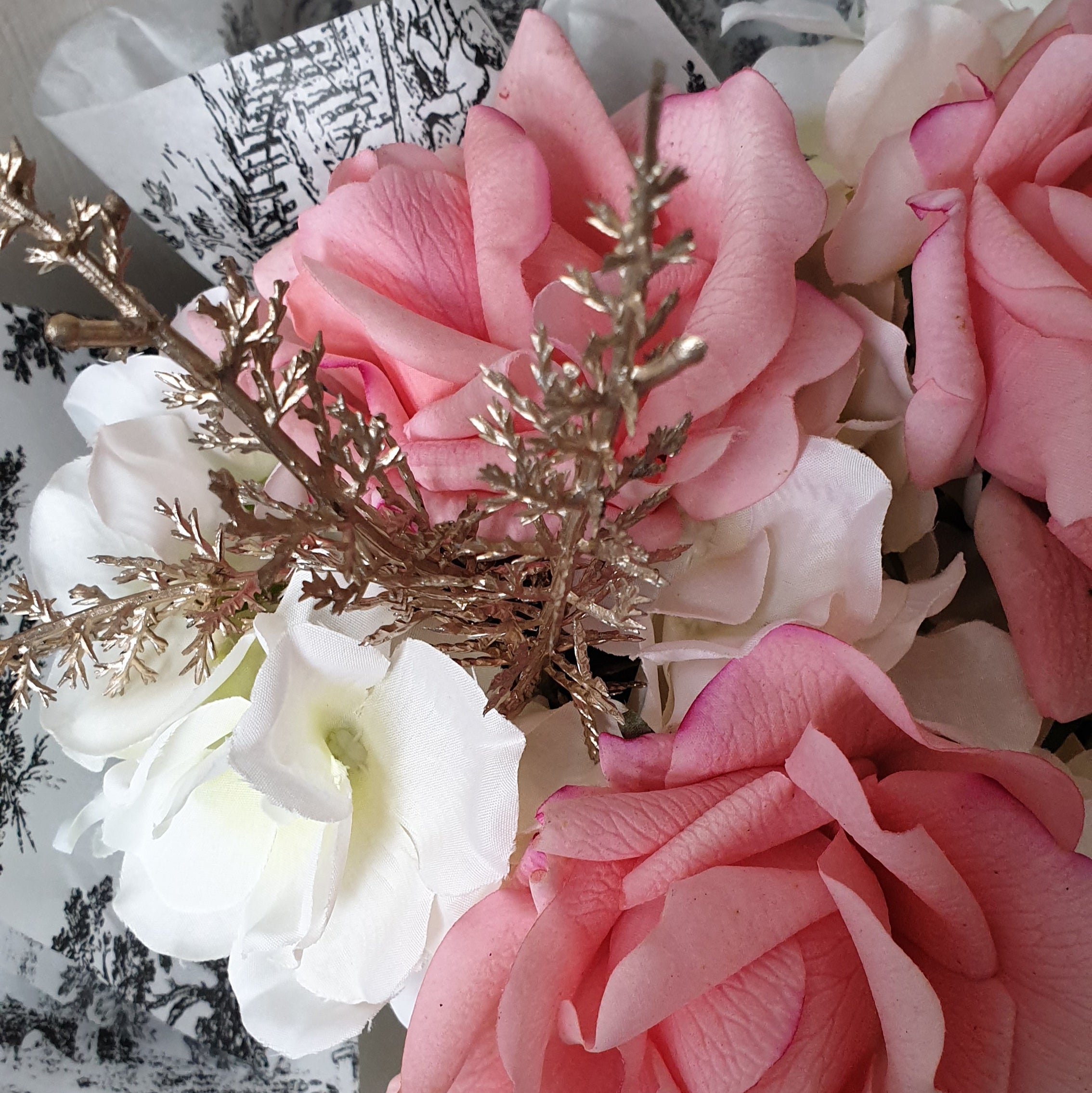 artificial wedding flowers - Bouquet of pink and white flowers with gold accents on a blurred background