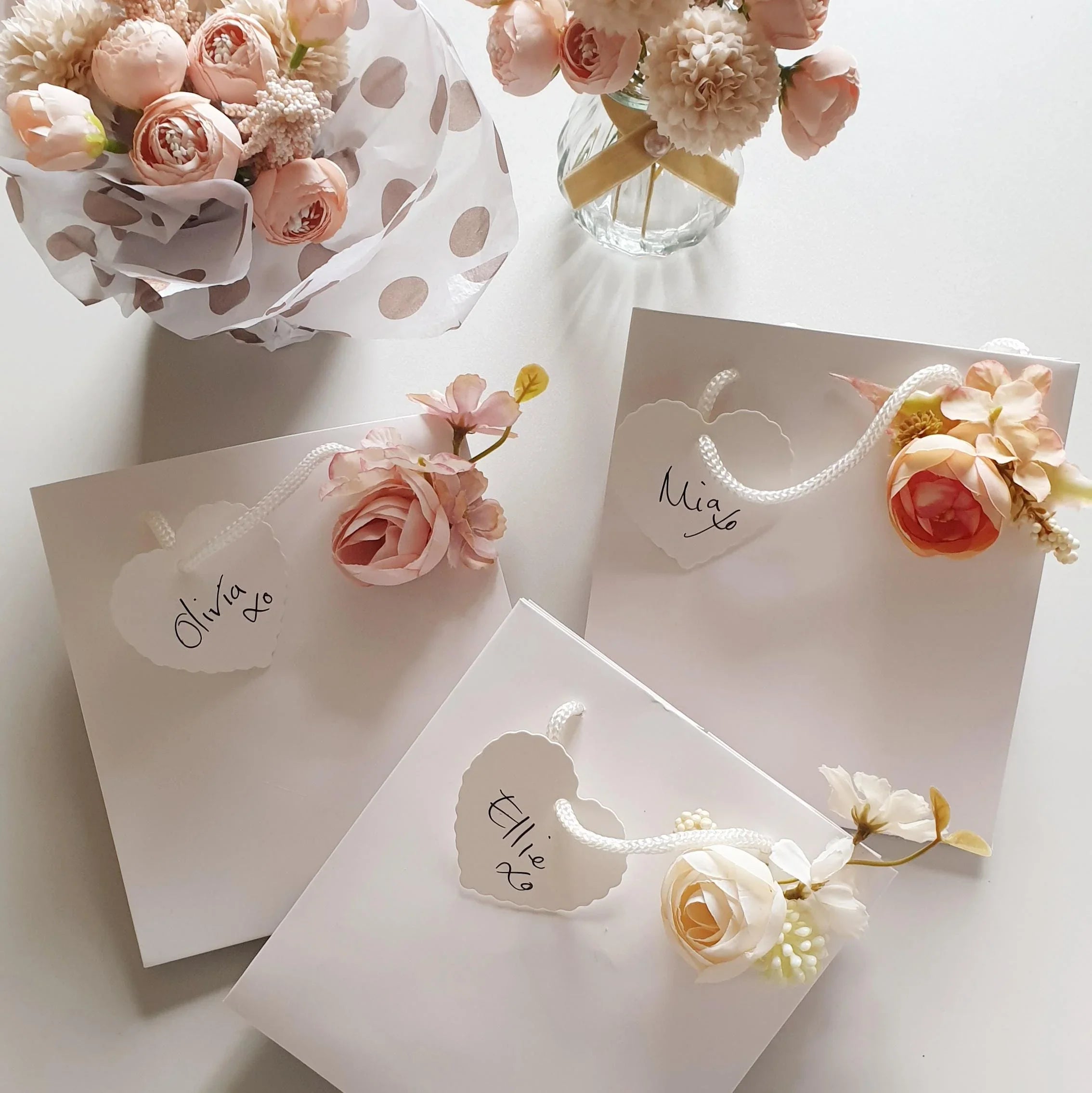 wedding flowers Cheshire - Floral arrangements and name tags on a light surface